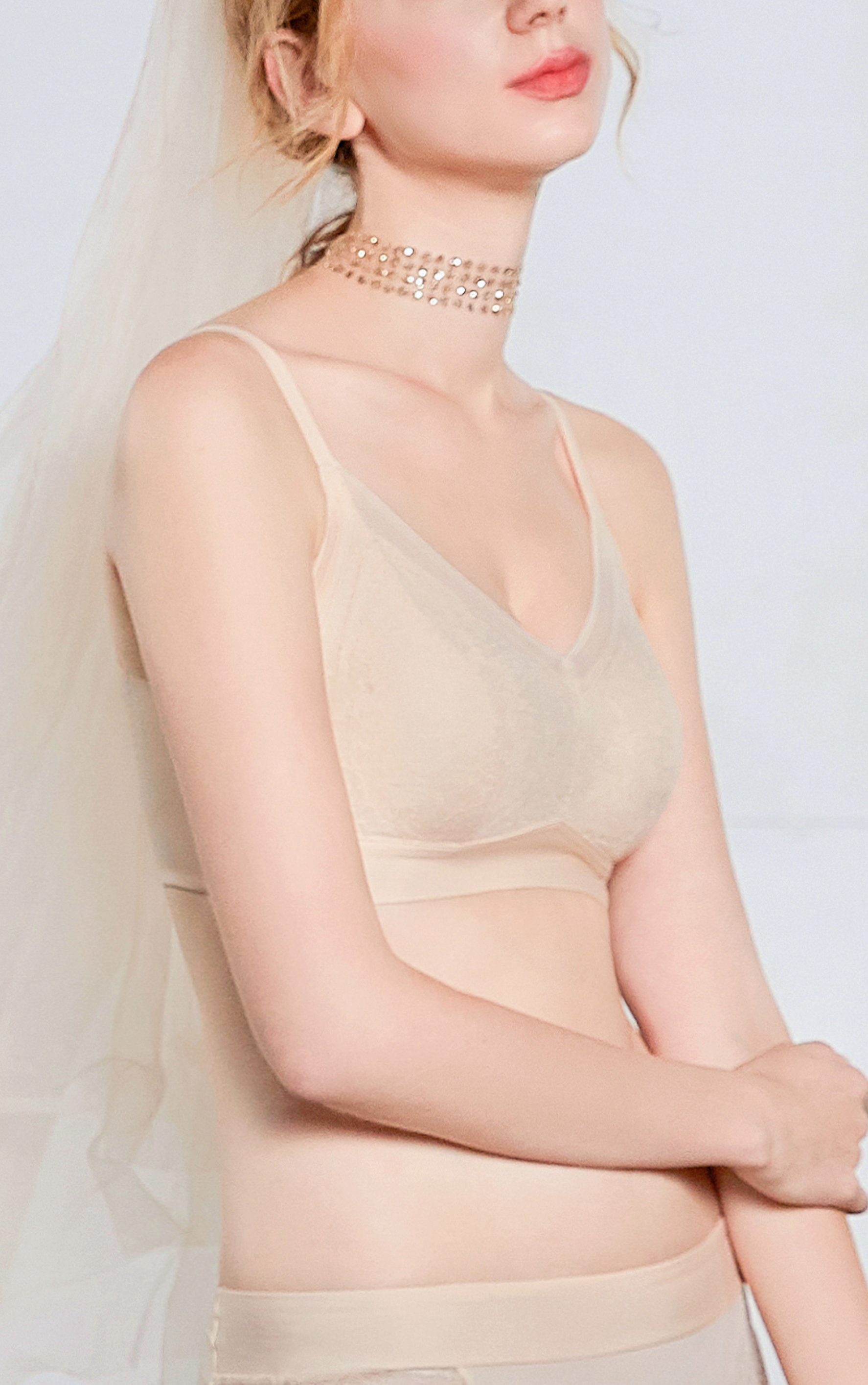 Angled view of beige wireless contour bra highlighting wide sidebands for back-smoothing support