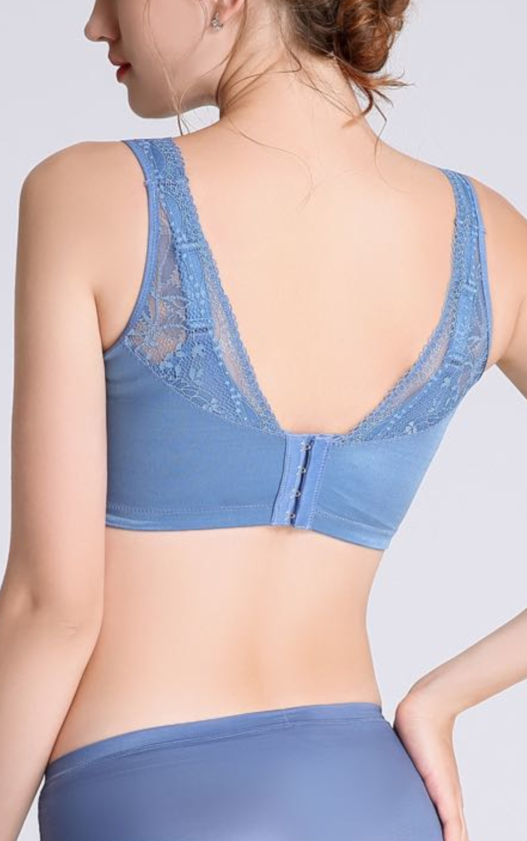 Side view of blue minimizer contour bra showing back-smoothing design and wide sidebands