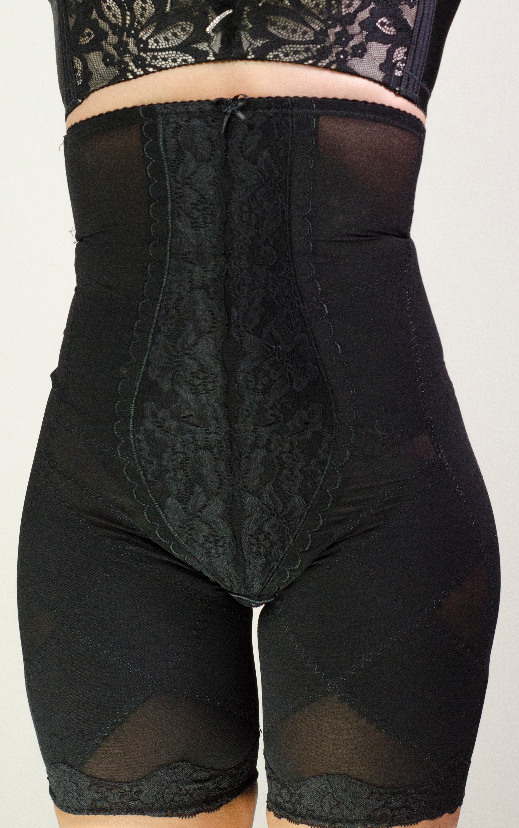 Side view of black high-waist lace thigh slimmer shapewear shorts with firm control