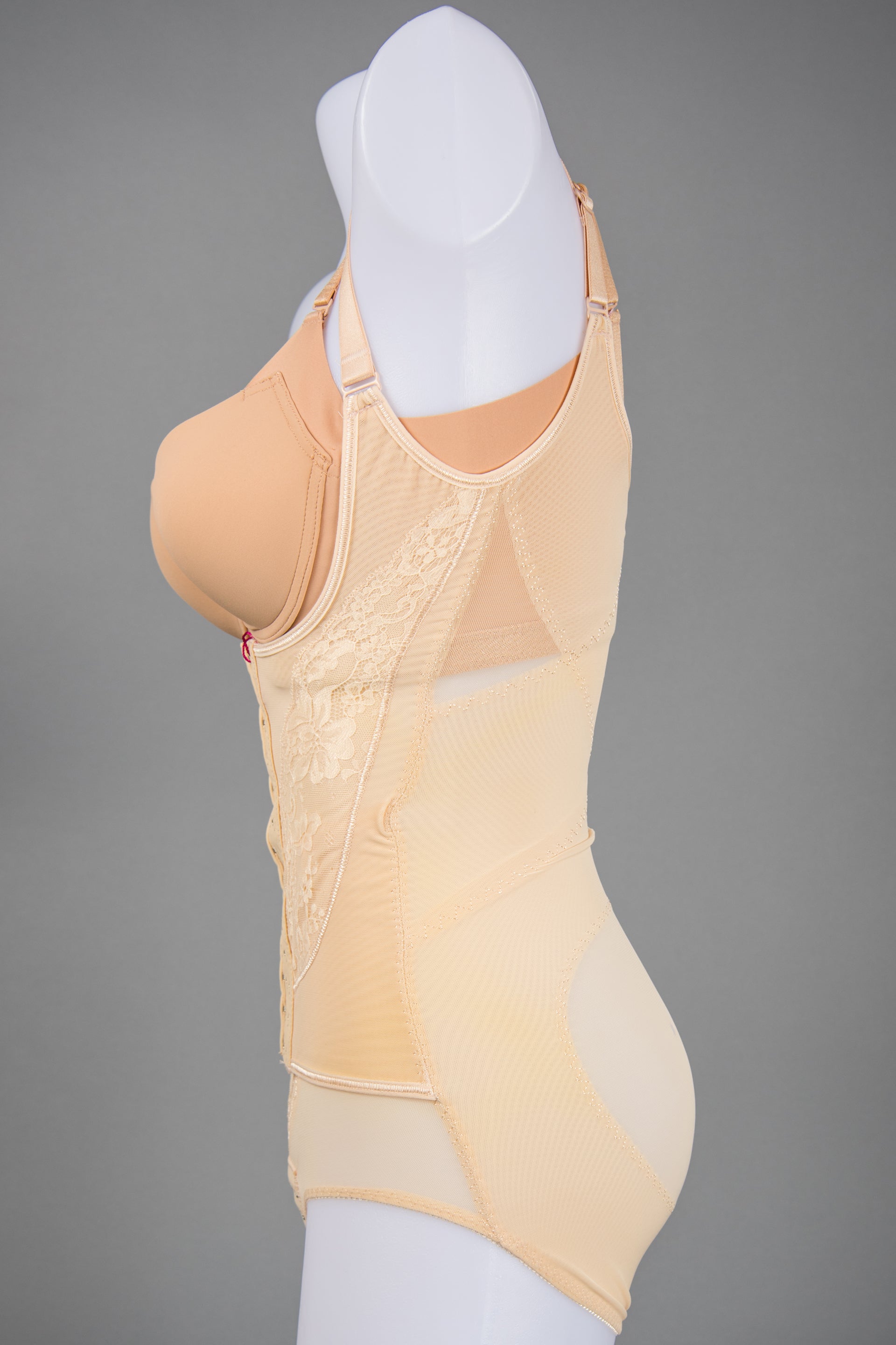Angled view of beige full body shaper shapewear bodysuit highlighting tummy control panel