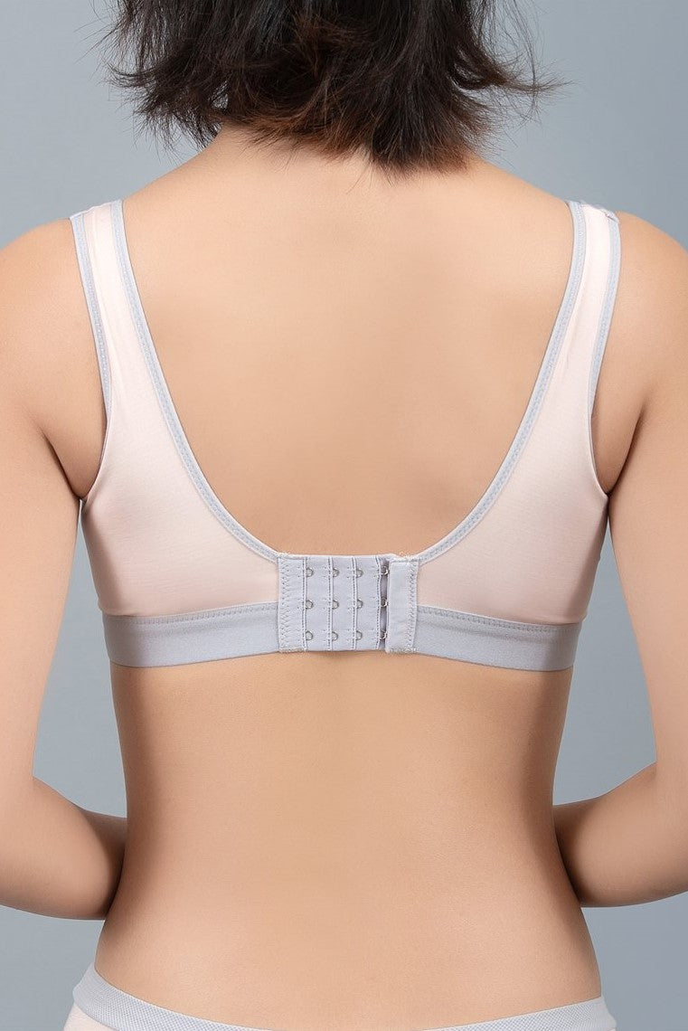 Back view of beige sports contour bra showing contrast mesh panel for breathability