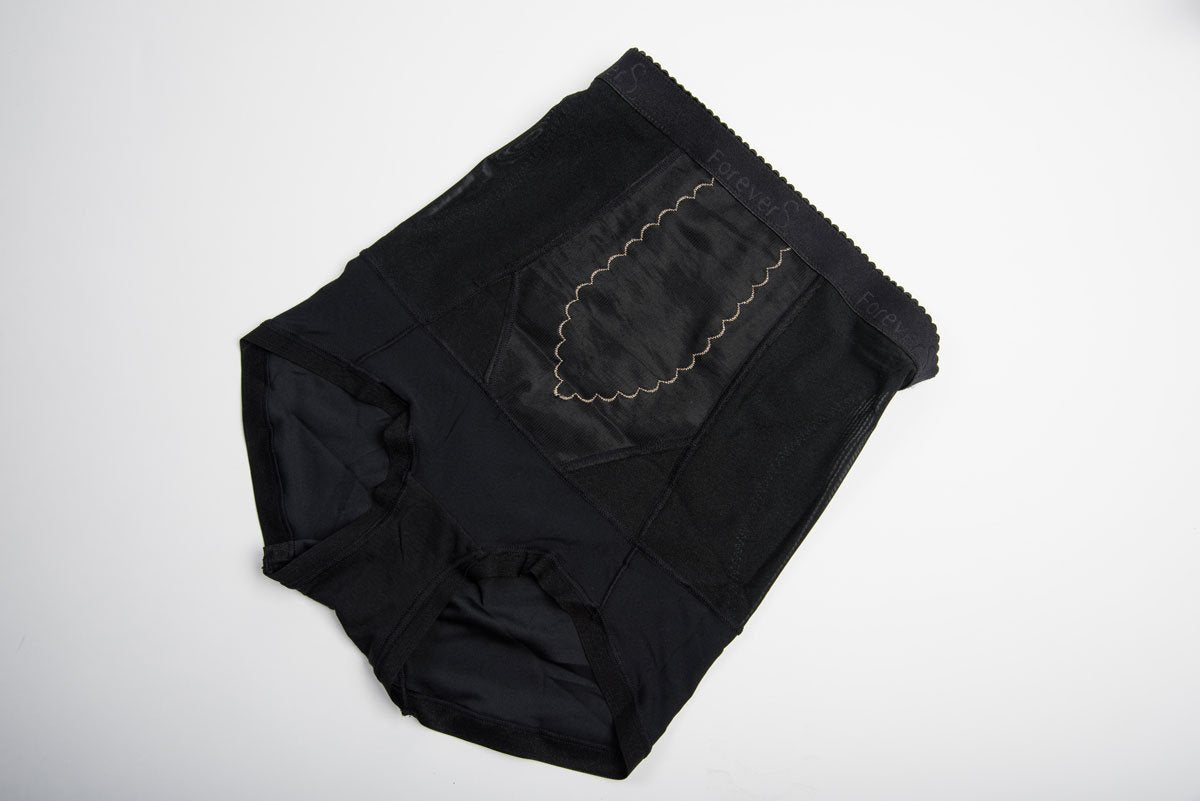 Detail view of beige charcoal fiber shapewear brief showing breathable fabric texture